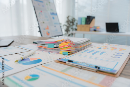 фотографія Businesswoman browsing through various documents, efficiently organizing files a