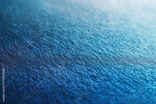 Textured blue denim jeans fabric with a detailed, macro pattern on a canvas surface