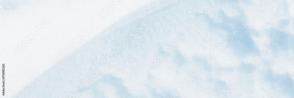 Fototapeta premium Wide panoramic winter background with snowy ground. Natural snow texture. Wind sculpted patterns on snow surface.