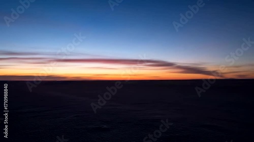 Vibrant streaks of light paint a dynamic scene at dusk, showcasing motion and color.