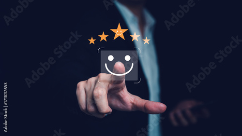Businessman touching happy smile face icon on digital screen, concept of online technology for customer satisfaction survey, feedback, and quality service improvement.