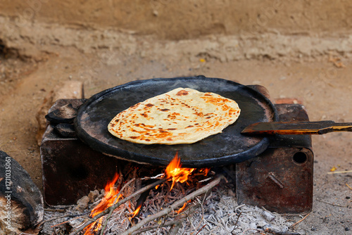 cooking on the grill
yufka flatbread cooked on a sheet of metal over a wood fire