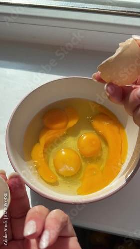 Woman preparing homemade omelette mixing with whisk eggs. Whisking scrambled eggs. process of making a scrambled egg omelet