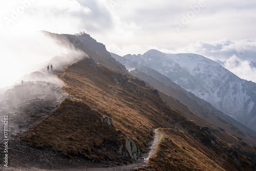people walking along a Tatra trail in the fog
