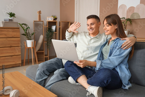 Young couple with laptop vi...