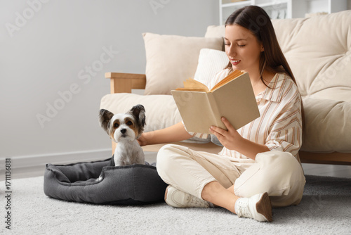 Young woman reading book on...