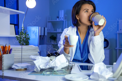 Female doctor with coffee w...
