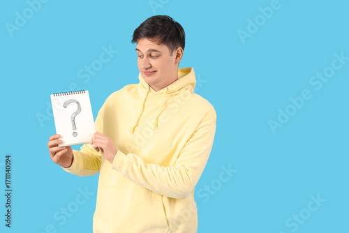 Young man holding notebook ...