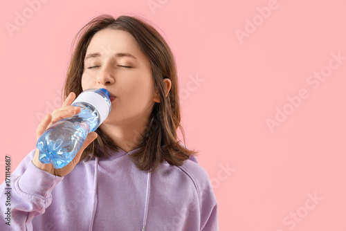 Young woman drinking water ...