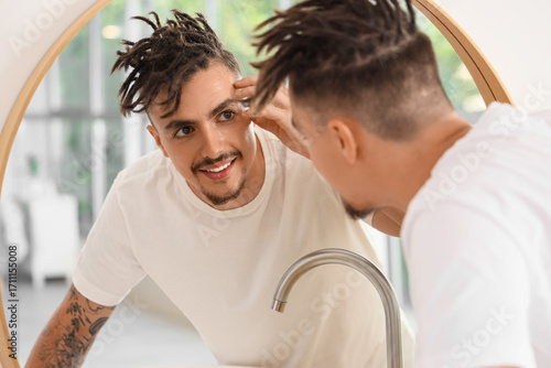 Young man with dreadlocks c...