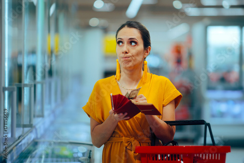 Stressed Woman Counting the Money in her Wallet. Shopper checking the prices feeling frustrated with her budget