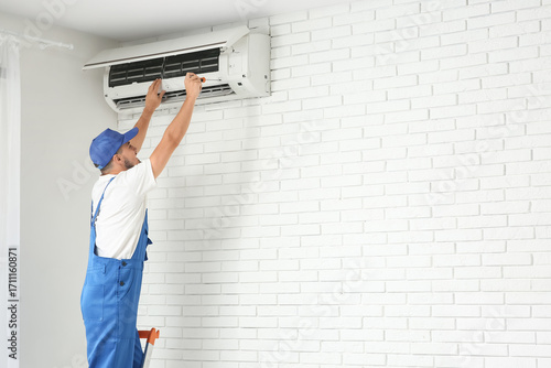Male technician with screwd...