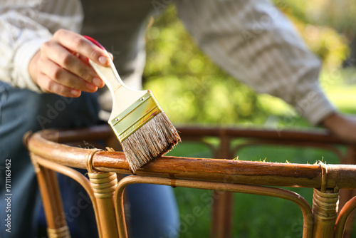 Woman painting table frame ...