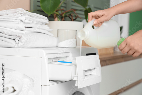 Person pouring liquid laund...