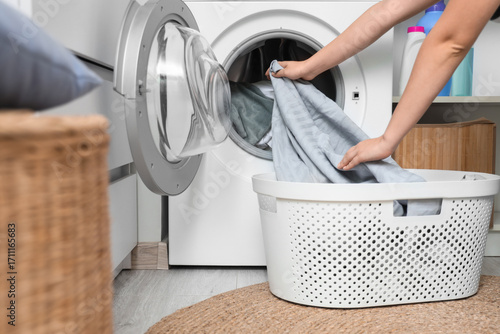 Person loading laundry into...