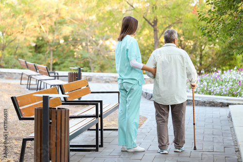Elderly patient walking wit...