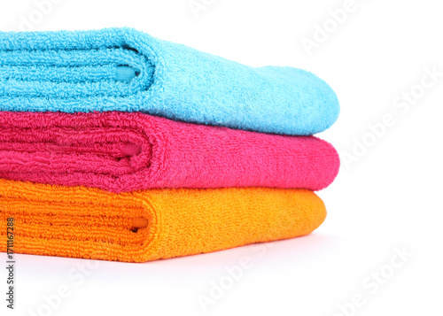 Stack of bright terry towels isolated on white
