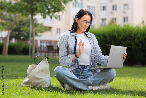 Young woman using laptop on...