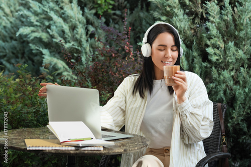 Young woman in headphones w...
