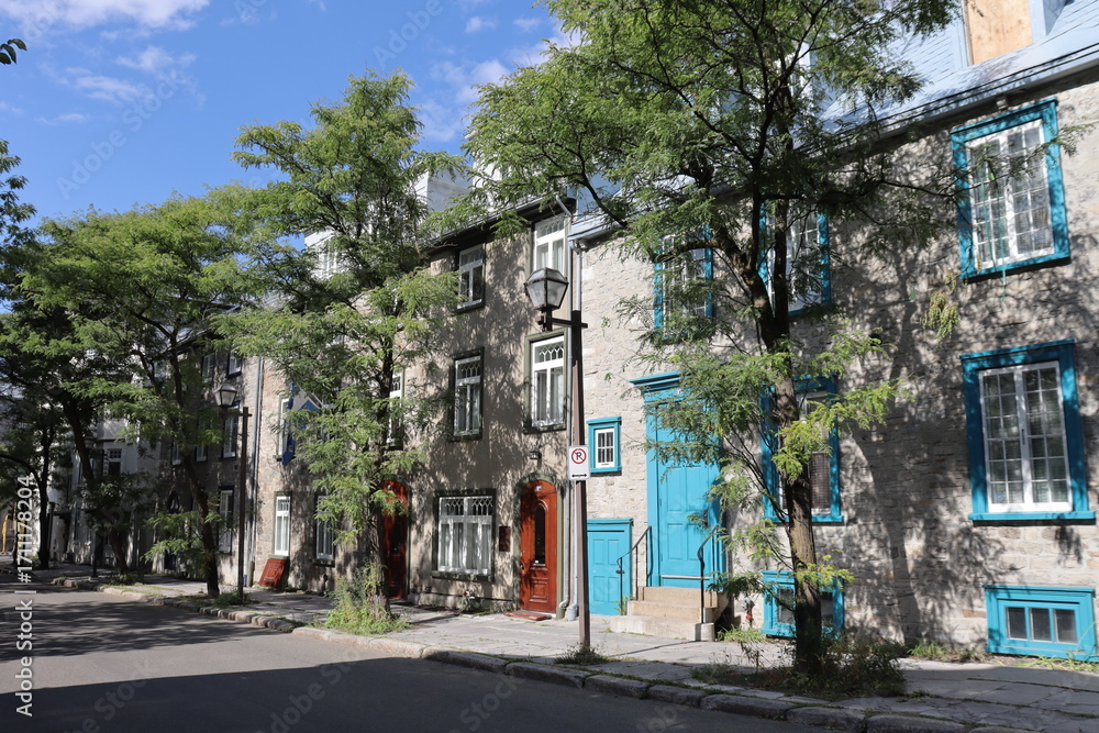 Fototapeta premium Old street in the Old Quebec in Canada with ancient architecture. Panorama of the old Quebec with ancient building. Historic building in Quebec city. Tourism and destination in Quebec.