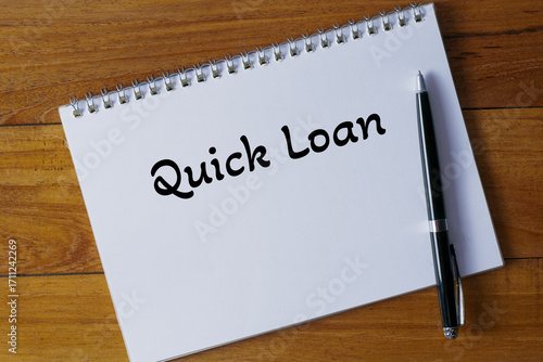 Quick Loan written in a notebook on wooden desk