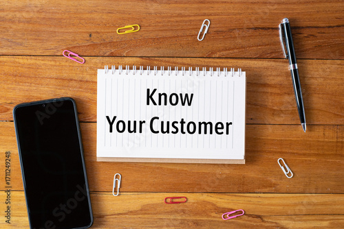 know your customer written in a notebook on wooden desk