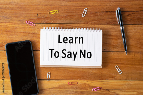 Learn to say no written in a notebook on wooden desk