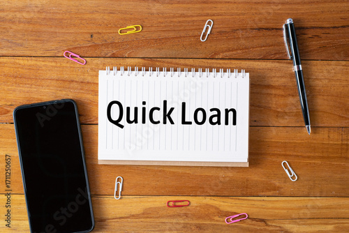 Quick Loan written in a notebook on wooden desk