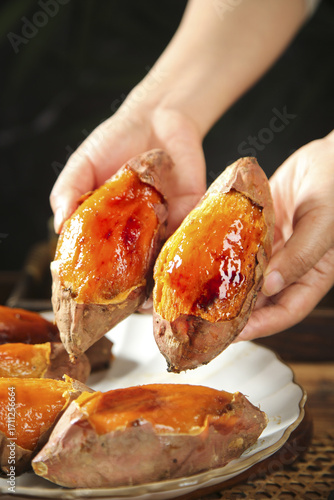 Fresh Baked Sweet Potatoes with Honey Glaze Held in Hands - Healthy Roasted Vegetable Food