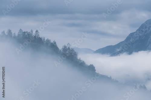 Cloudy sky and morning fog over the hills and mountains.