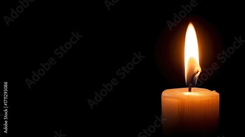 Candle flame burning steadily in darkness with warm light glow from wax wick fire creating calm peaceful atmosphere symbolizing resilience and hope