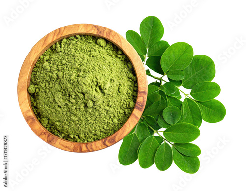 Moringa powder in a wooden bowl with fresh leaves