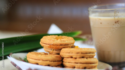 Breakfast and snack menu. Butter biscuits with pineapple jam and a glass of chocolate milk. Close-up of butter cookies and a glass of chocolate, sweet cakes. Perfect for recipes, articles, catalogs.