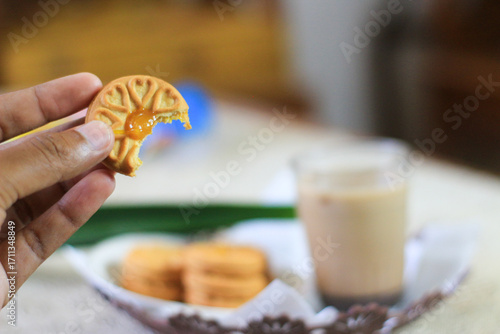 Breakfast and snack menu. Butter biscuits with pineapple jam and a glass of chocolate milk. Close-up of butter cookies and a glass of chocolate, sweet cakes. Perfect for recipes, articles, catalogs.