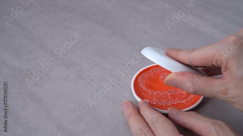 Opening Orange Dental Aligner Case that orthodontic mouthpiece storaged. Slow motion video.
