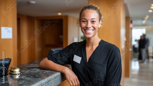 Smiling receptionist welcoming guests at business hotel lobby professional environment engaging atmosphere