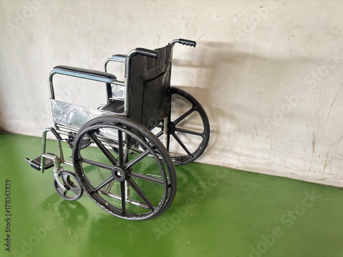 Wheelchair with Black Seat and Large Wheels in Indoor Setting