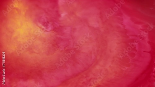 Mix paint. Acrylic drop. Defocused pink yellow red color water liquid shiny emulsion fluid on abstract art creative bright background.
