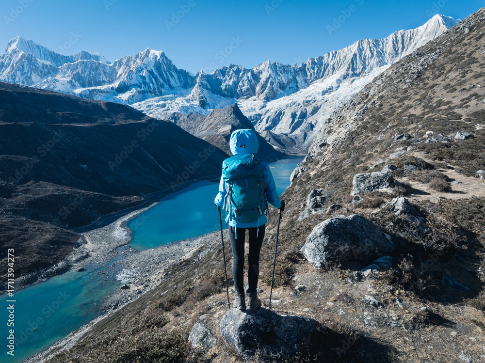 Naklejka premium Successful woman hiker on high altitude mountain top
