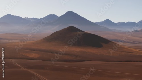 Aerial shot of the majestic mountains and volcanoes in the Atacama highlands captured in summer under clear skies showing the vast and remote beauty of the Chilean altiplano