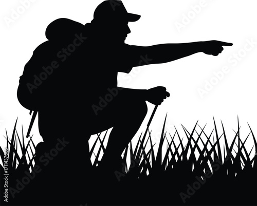 Hiker pointing forward in a grassy field silhouette