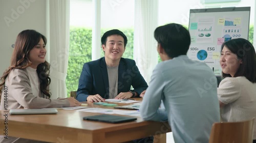 Happy workplace diverse team group young adult gen Z asia people man woman candid work at office class enjoy talk laugh relax idea advice in go green eco friendly future growth worker mental health.