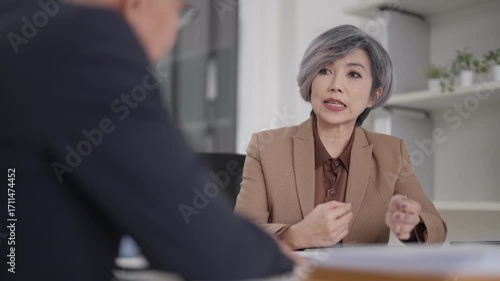 Asian adult woman professional discusses business office consultant gives expert advice serious meeting