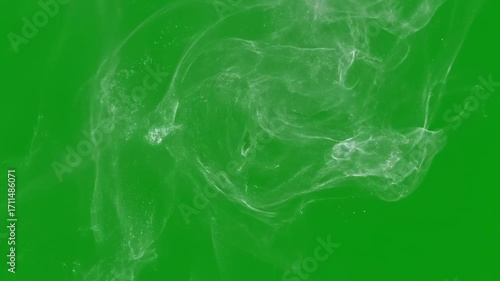 Wide spread of small, scattered confetti gently settling on an invisible surface, isolated on a green background texture, movement, visual