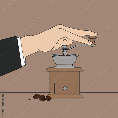 Hand grinds beans in a vintage coffee grinder on a brown surface near scattered coffee beans