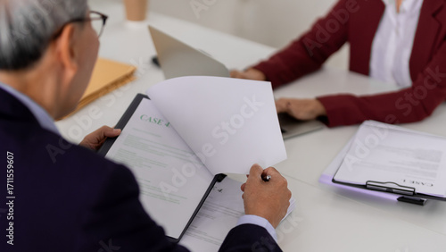 Schilderij op canvas Legal professionals review case documents office setting for compliance and cons