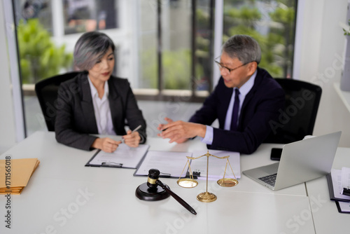 Wallpaper Mural Asian adult legal professionals consult justice equity discuss vital case details for client representation in professional modern office environment legal advice Torontodigital.ca