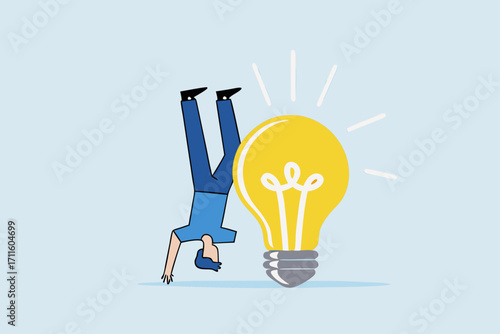 Think different to create unique idea, entrepreneur who contemplates concept with light bulb in different location.