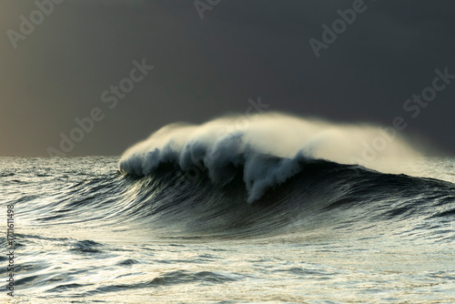 Powerful ocean waves rolling at sunrise after a storm off Sydney, Australia, with dramatic sea and sky.