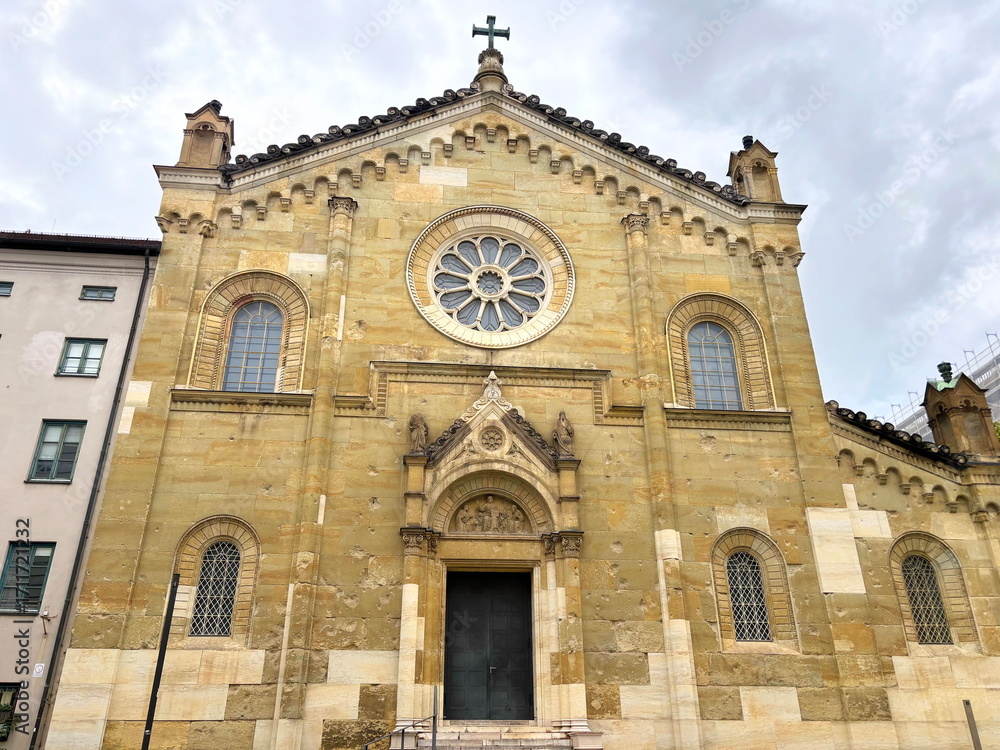 Fototapeta premium Looking up at the upholstered walls of the facade of the old Catholic church All Saints' Court Church in Munich.
